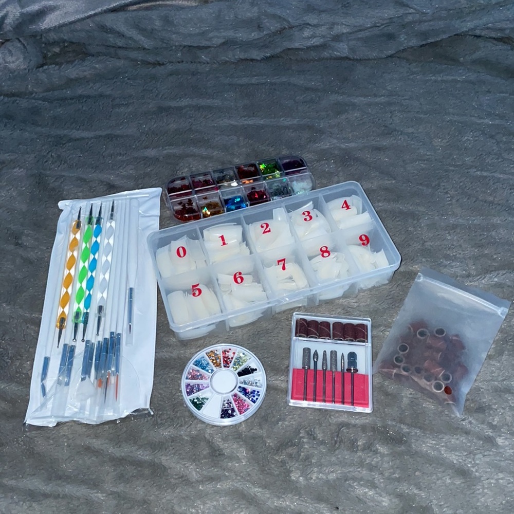 Nail bundle including tips,gems,drill bits,and polish designing brushes/tools